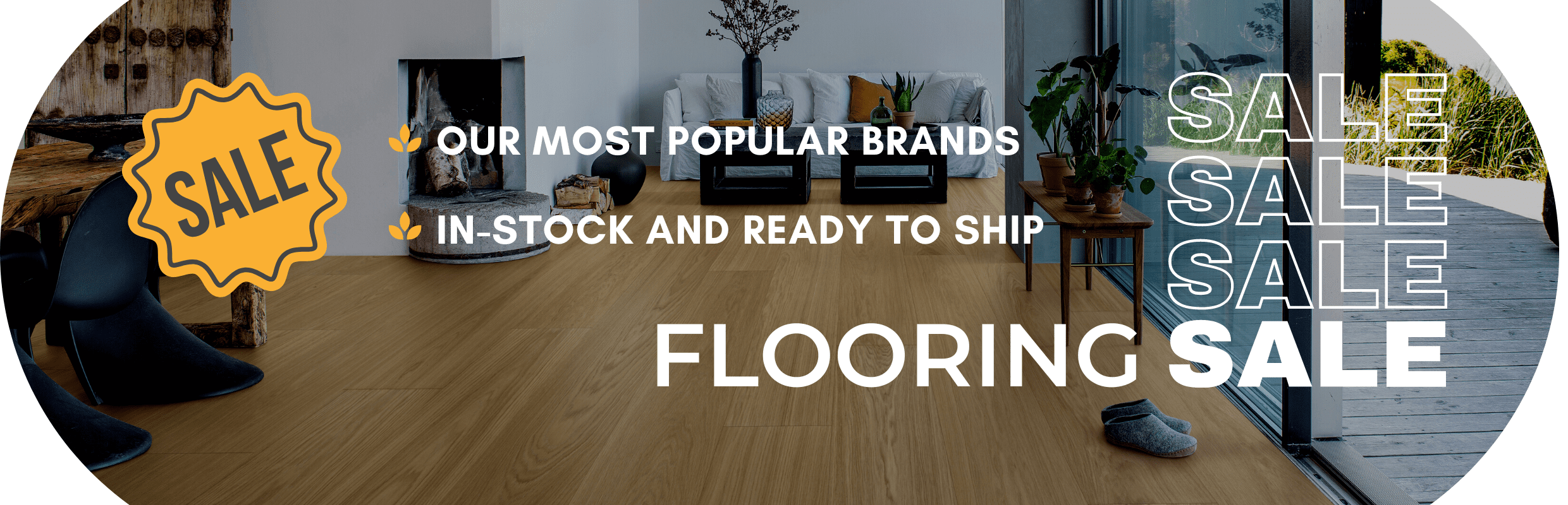 Image of a light-filled living room with light oak wide plank hardwood flooring.